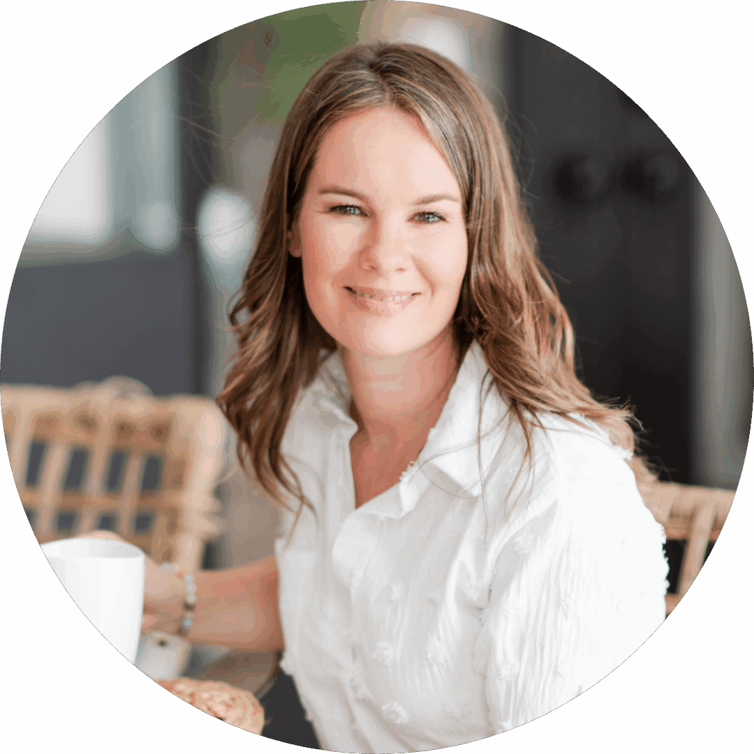 Smiling woman with wavy hair in a white blouse.